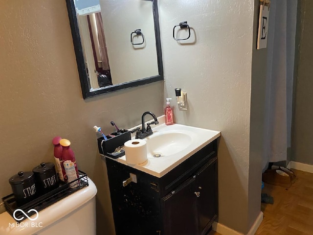 bathroom with vanity and toilet