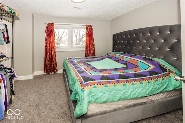 carpeted bedroom featuring a textured ceiling