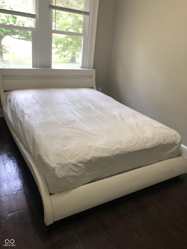 bedroom with wood-type flooring