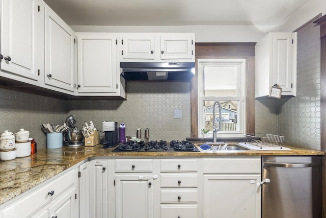 kitchen featuring decorative backsplash, dishwasher, white cabinets, and range hood