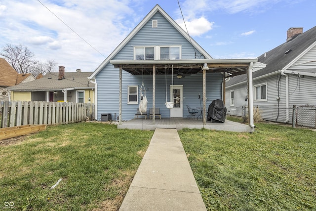 back of property with a lawn and central air condition unit