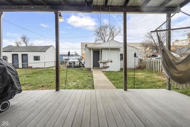 wooden terrace featuring a lawn