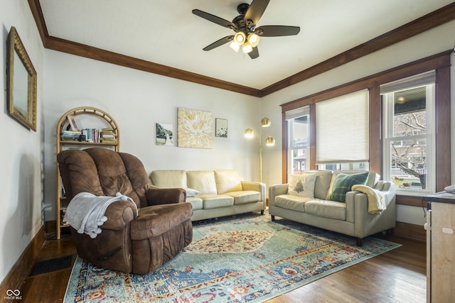 living room featuring ceiling fan, dark hardwood / wood-style flooring, and crown molding