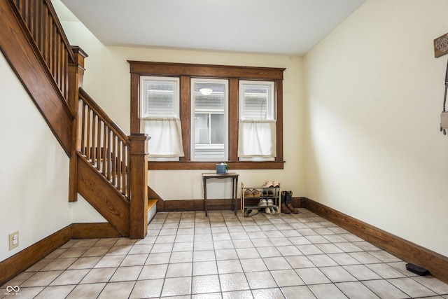 empty room with plenty of natural light and light tile patterned floors