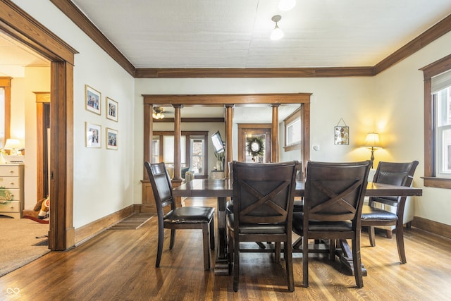 dining space featuring hardwood / wood-style flooring and crown molding