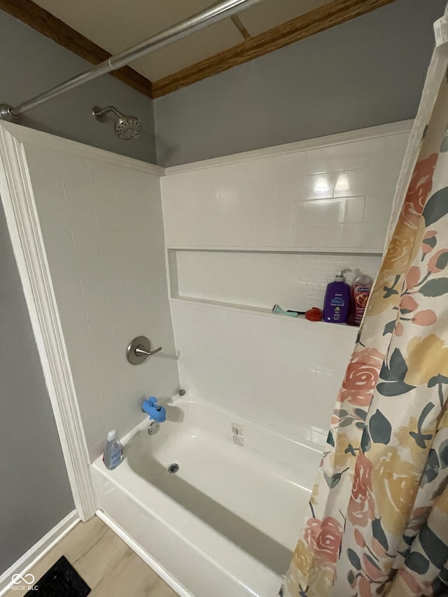 bathroom featuring hardwood / wood-style flooring and shower / bath combo with shower curtain