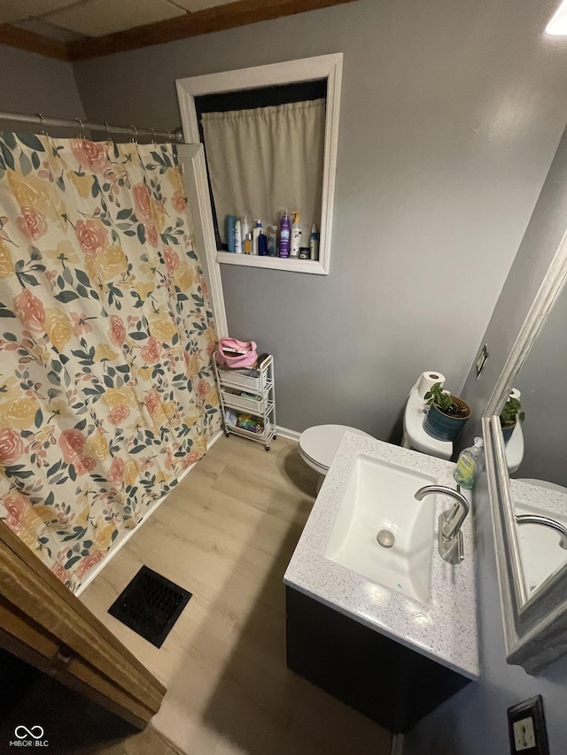 bathroom featuring hardwood / wood-style floors, vanity, and toilet