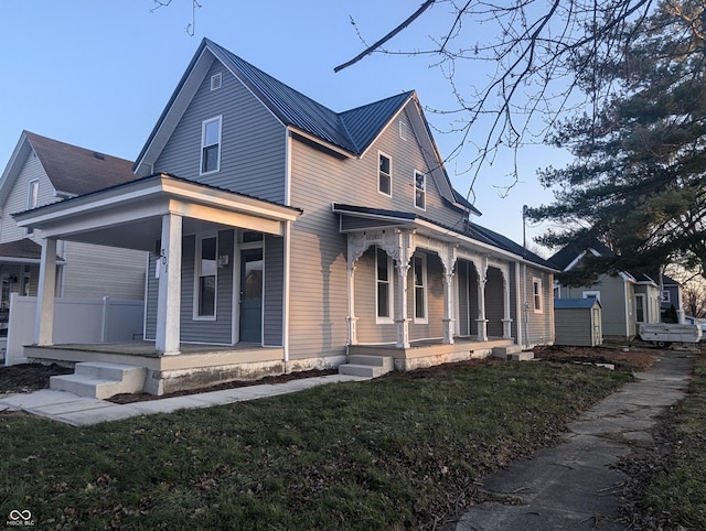 view of front of home featuring covered porch and a front yard