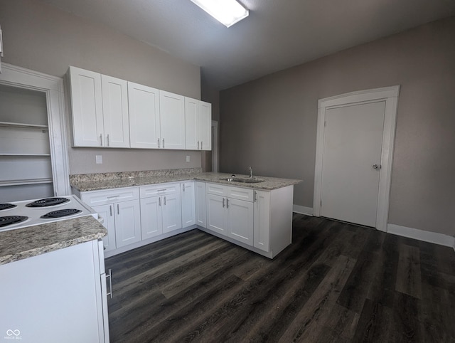 kitchen with sink, dark wood-type flooring, light stone counters, kitchen peninsula, and white cabinets