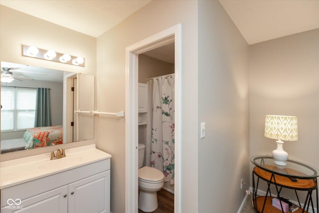 bathroom featuring vanity, hardwood / wood-style flooring, ceiling fan, toilet, and curtained shower