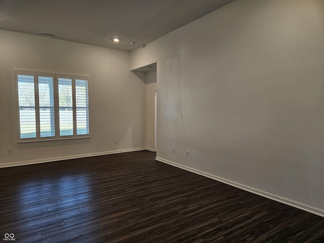 spare room featuring dark wood-type flooring