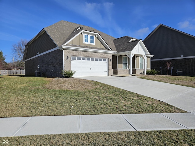 craftsman inspired home featuring a front lawn, central AC unit, and a garage