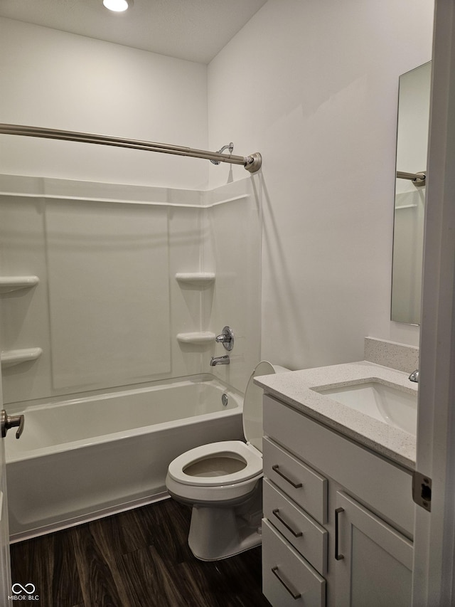 full bathroom featuring vanity, toilet, wood-type flooring, and shower / tub combination