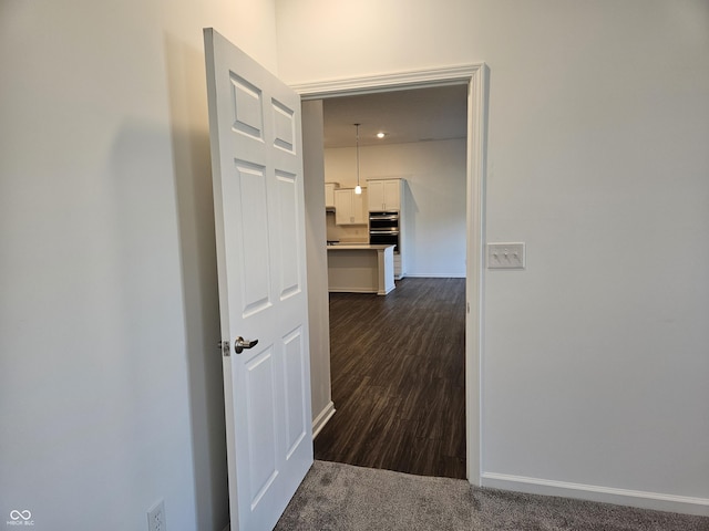 corridor with dark colored carpet