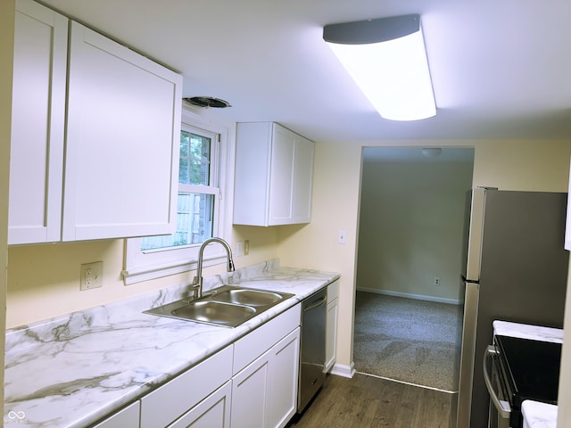 kitchen with dark hardwood / wood-style flooring, white cabinets, sink, dishwasher, and range