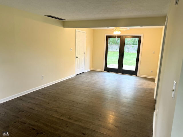 spare room with ceiling fan, french doors, and dark hardwood / wood-style floors