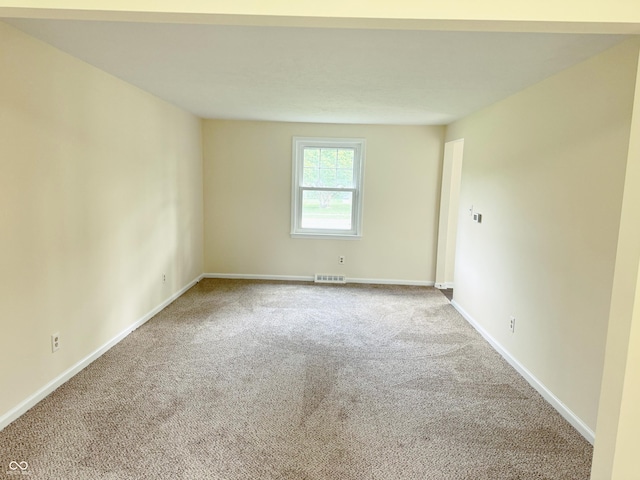 unfurnished room featuring carpet