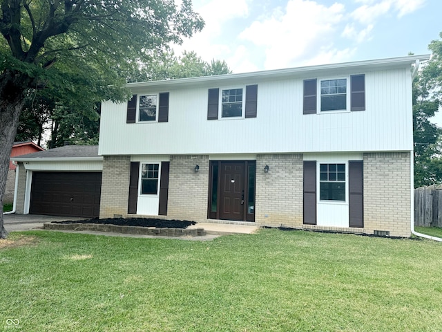 view of front of home with a front yard and a garage