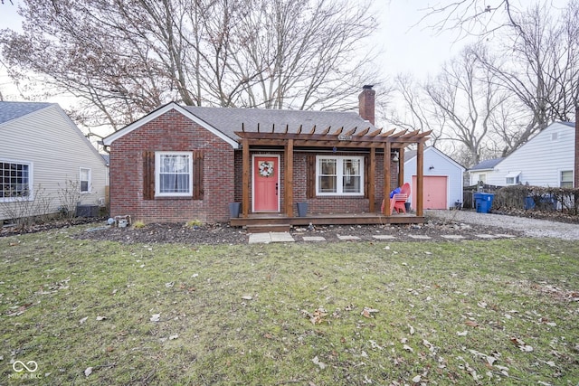 view of front of property with a pergola, a front yard, and a garage