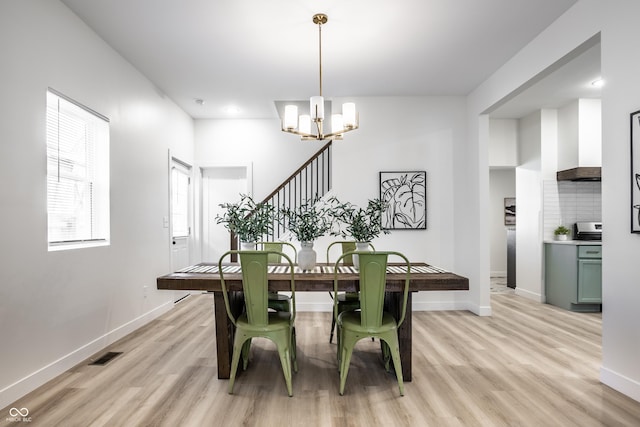 dining room featuring a chandelier and light wood-type flooring