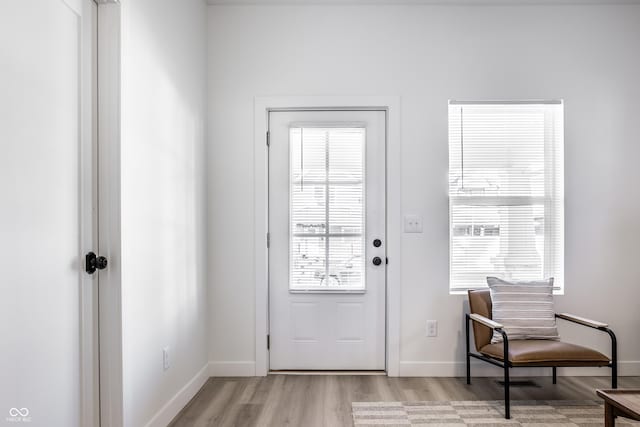 doorway to outside with light wood-type flooring