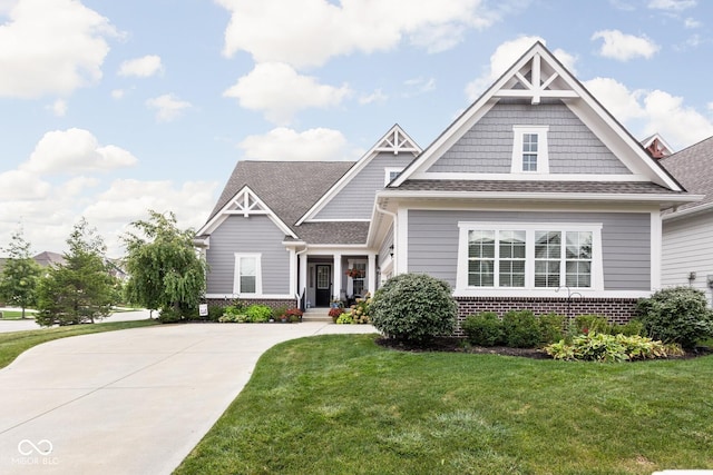 craftsman inspired home with a front lawn