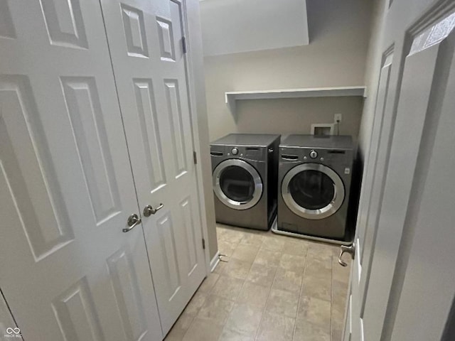 clothes washing area with washer and clothes dryer