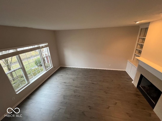 unfurnished living room with dark hardwood / wood-style floors