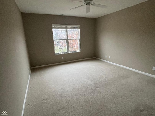 empty room featuring carpet floors and ceiling fan