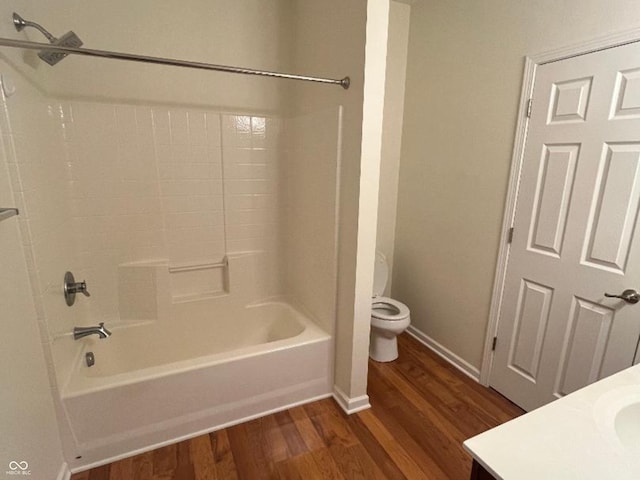 full bathroom with shower / washtub combination, vanity, wood-type flooring, and toilet