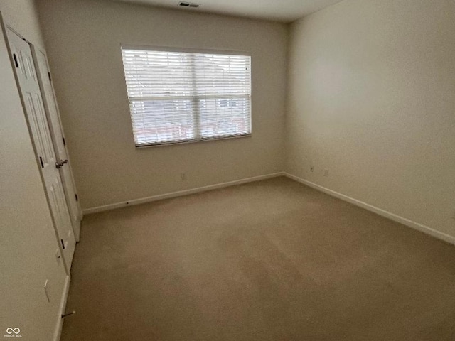 unfurnished room with light carpet