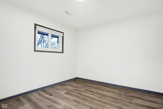 unfurnished room with dark hardwood / wood-style flooring