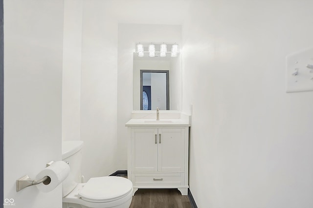 bathroom featuring hardwood / wood-style floors, vanity, and toilet