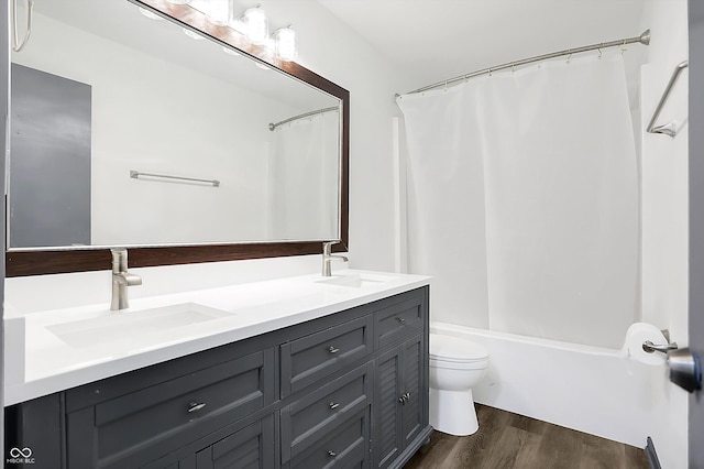 full bathroom with hardwood / wood-style floors, vanity, toilet, and shower / bathtub combination with curtain