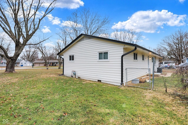 view of side of home featuring a lawn