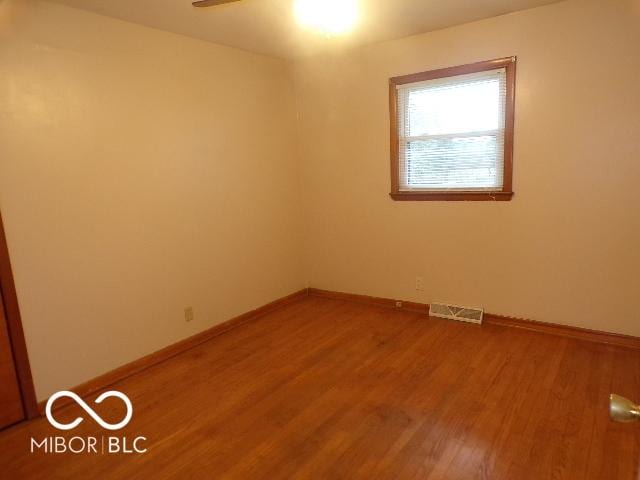 unfurnished room with wood-type flooring