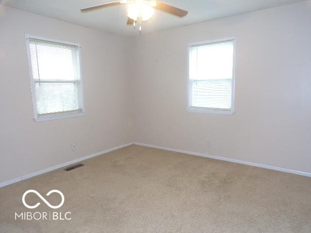 carpeted empty room featuring ceiling fan