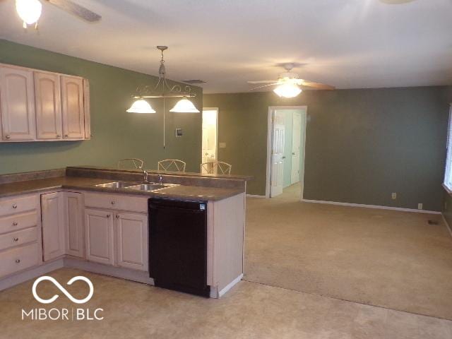 kitchen featuring sink, ceiling fan, black dishwasher, decorative light fixtures, and light colored carpet