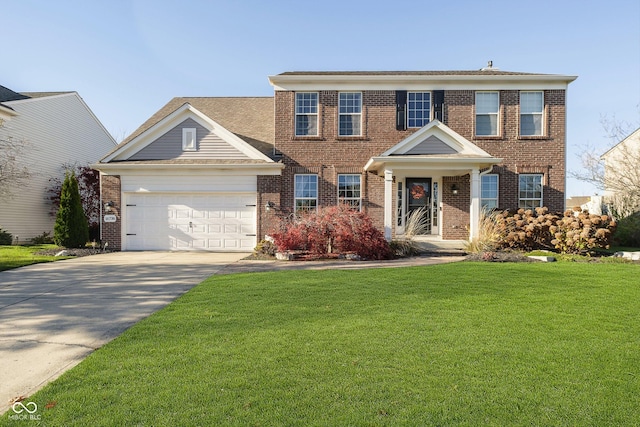 colonial home featuring a front lawn and a garage