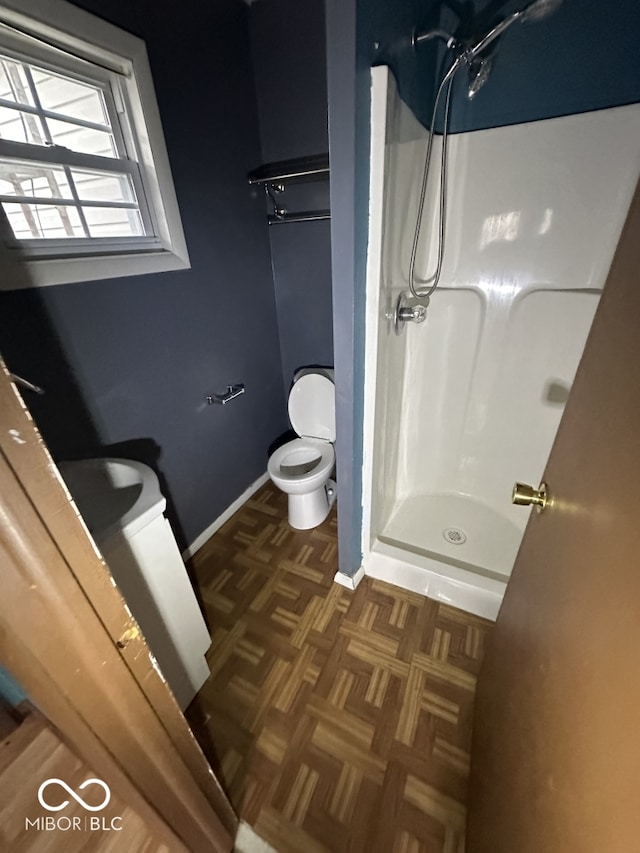 bathroom with toilet and a shower