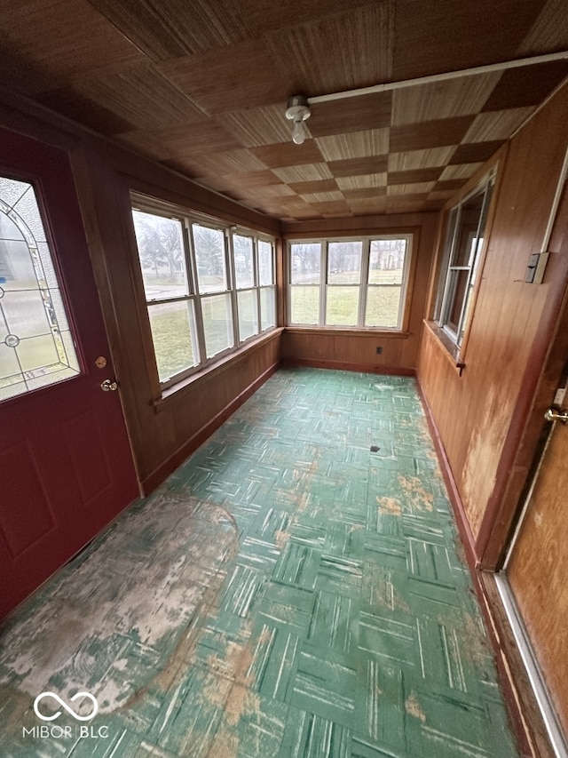 unfurnished sunroom featuring wood ceiling