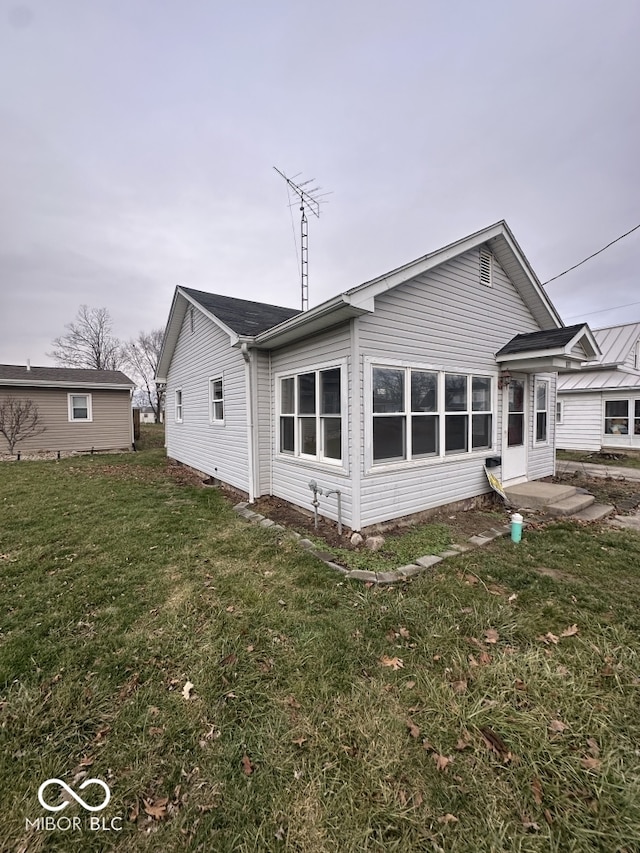 back of house with a lawn