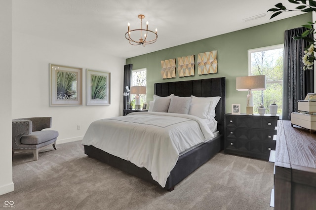 bedroom with a notable chandelier and carpet floors