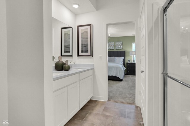 bathroom featuring vanity and a shower with shower door