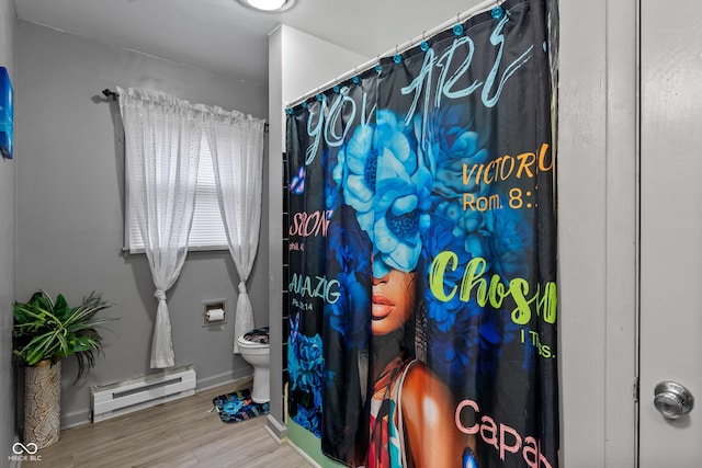 bathroom with a baseboard heating unit, hardwood / wood-style floors, and toilet