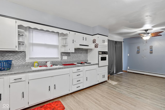 kitchen featuring sink, white appliances, light hardwood / wood-style flooring, baseboard heating, and white cabinetry