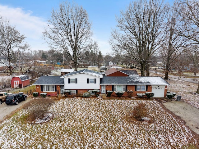 split level home with a garage and a shed