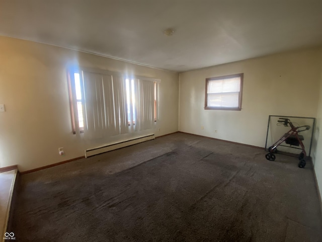 unfurnished room with a baseboard radiator and carpet