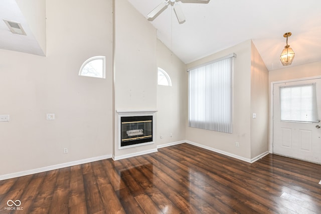 unfurnished living room with dark hardwood / wood-style flooring, ceiling fan, and a healthy amount of sunlight