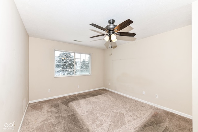 carpeted spare room with ceiling fan